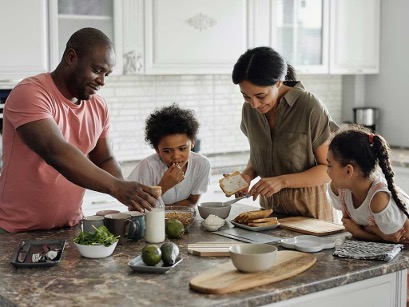 A couple and their two children around the kitchen island